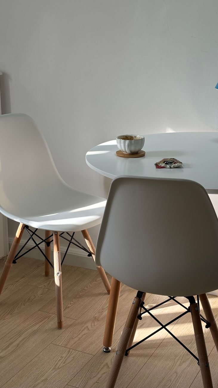 Light-filled minimalist dining area with modern chairs and table.