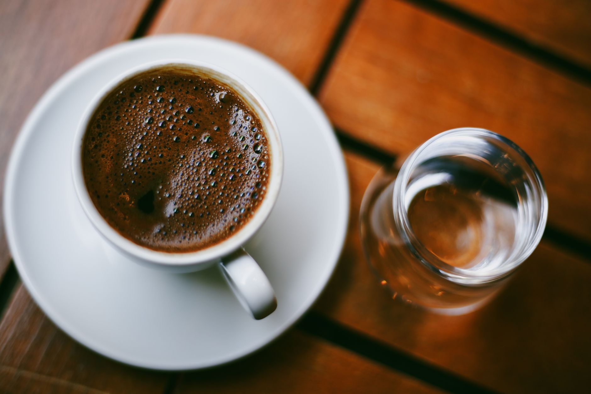 Enjoy a cup of traditional Turkish coffee with water at an outdoor café in İstanbul, Türkiye.