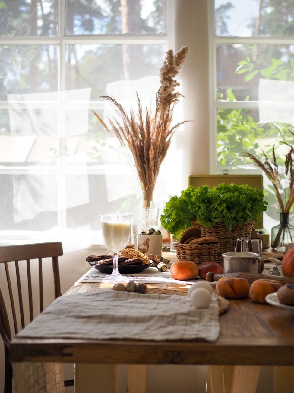 Cozy sunlit dining setup with fresh produce on a rustic table, perfect for a wholesome breakfast.